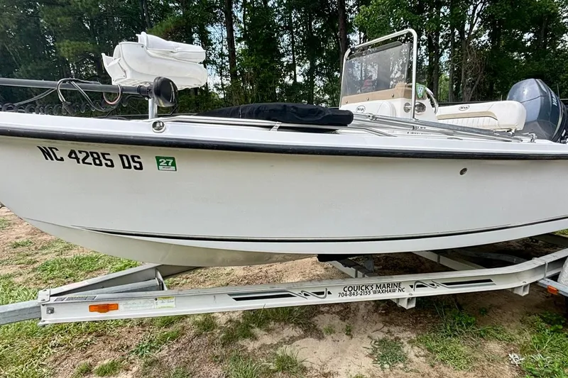 Slide: The Image of 2011 Key West 1720 Center Console boat on trailer, parked on grass. - 6