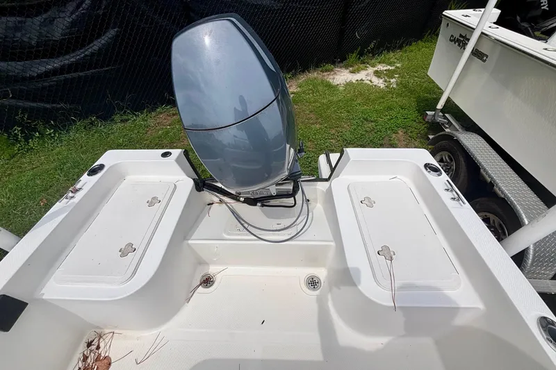 Slide: The Image of 2011 Key West 1720 Center Console boat with outboard motor, parked on grass. - 7