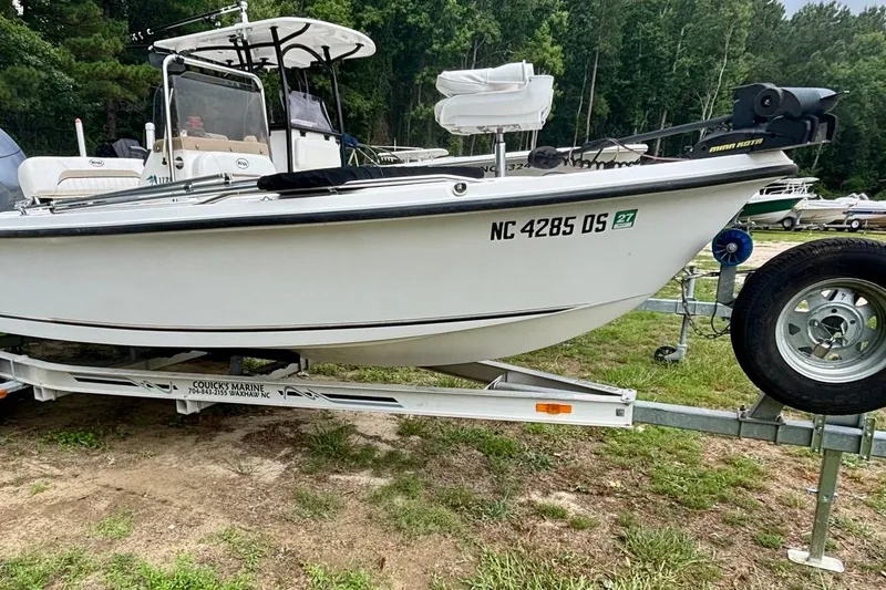 The Image of 2011 Key West 1720 Center Console boat on trailer, parked on grass. - 1