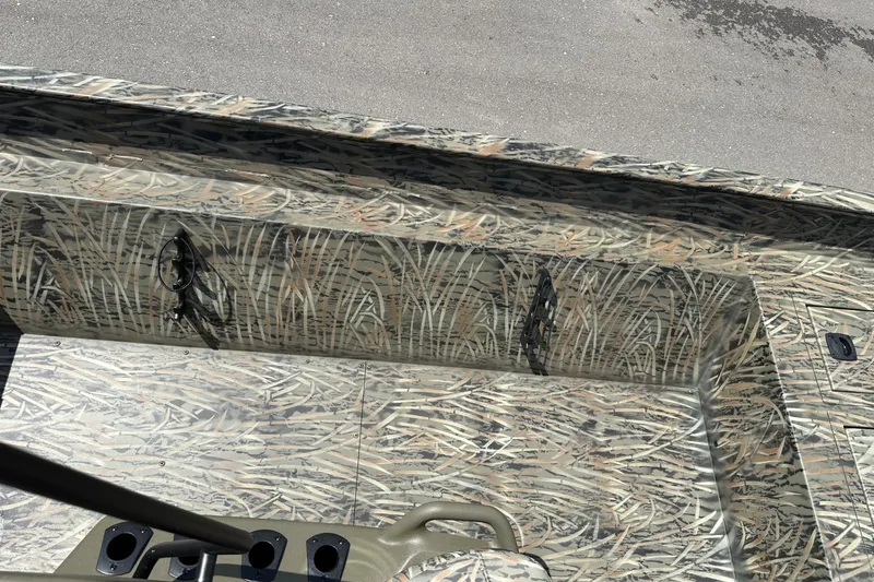 Slide: The Image of 2026 Tracker Grizzly 2072 CC boat interior with camouflage pattern and rod holders. - 16