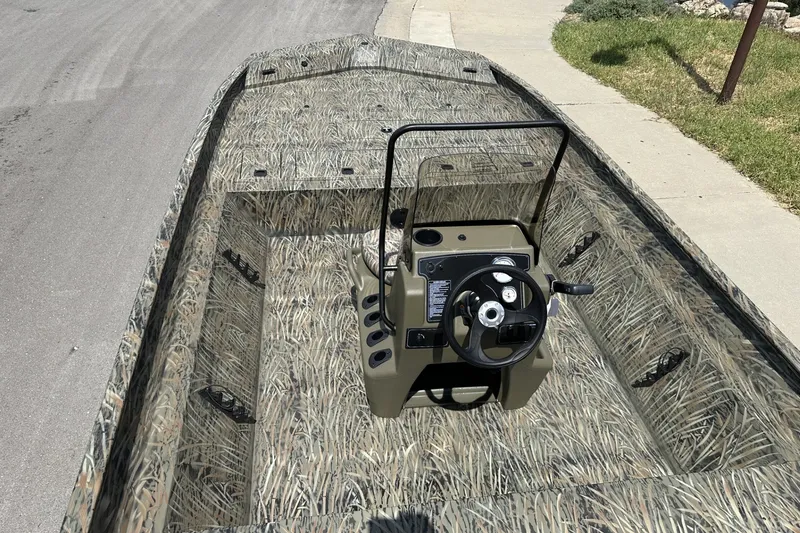 Slide: The Image of 2026 Tracker Grizzly 2072 CC boat with camouflage design on a street. - 20