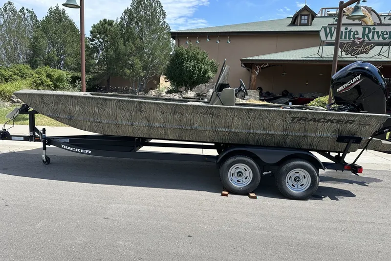 The Image of 2026 Tracker Grizzly 2072 CC boat on trailer, parked near White River Fly Shop. - 0