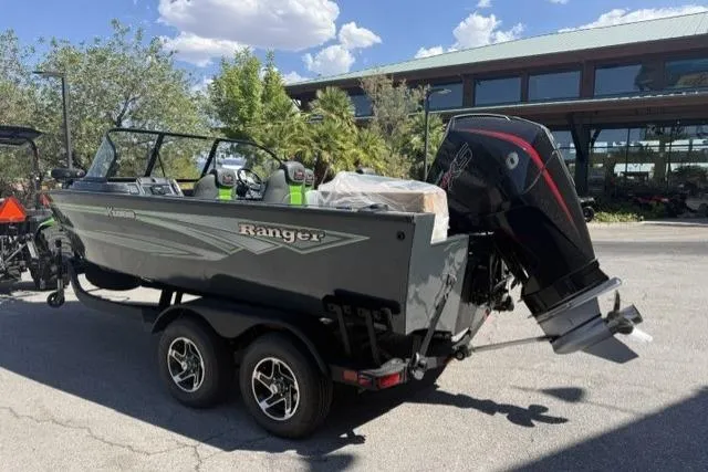 Slide: The Image of 2026 Ranger VX1888 WT boat on trailer, parked outdoors under a sunny sky. - 3
