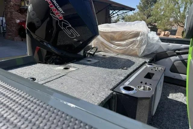 Slide: The Image of 2026 Ranger VX1888 WT boat interior with Mercury Pro XS engine, featuring carpeted deck and cup holders. - 10
