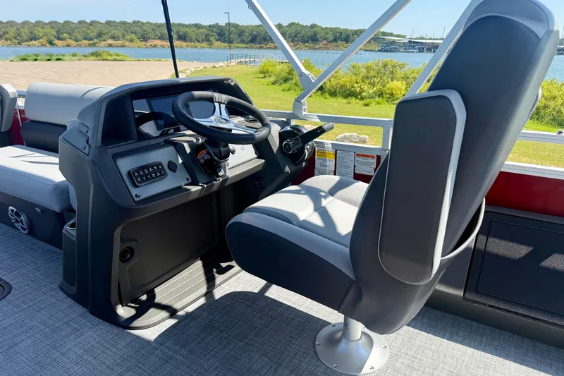 Slide: The Image of Interior of 2026 Sun Tracker Sportfish 24 XP3 boat, featuring steering console and seating. - 7