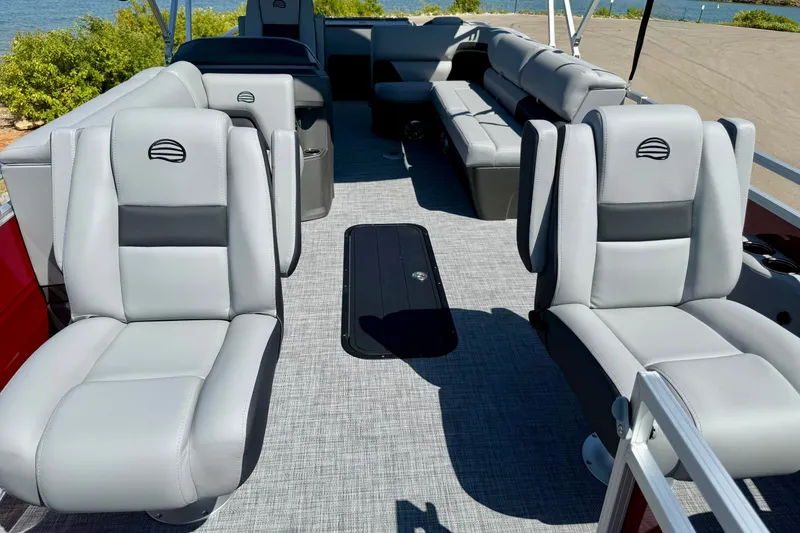 Slide: The Image of Luxurious seating on 2026 Sun Tracker Sportfish 24 XP3 pontoon boat, with scenic water view. - 15