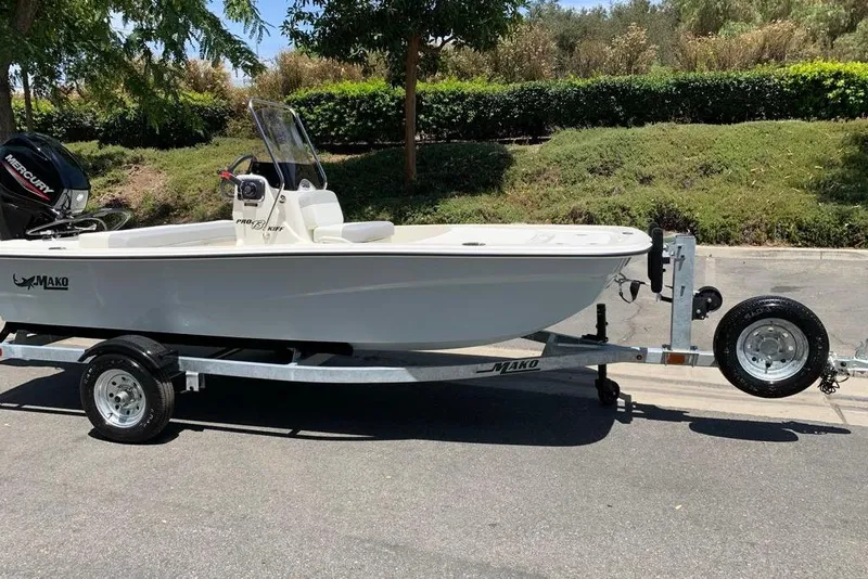 Slide: The Image of 2026 Mako Pro Skiff 13 CC boat on trailer, parked outdoors. - 3