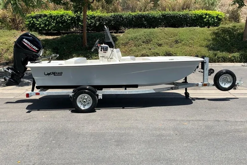 The Image of 2026 Mako Pro Skiff 13 CC boat on trailer, parked outdoors. - 0