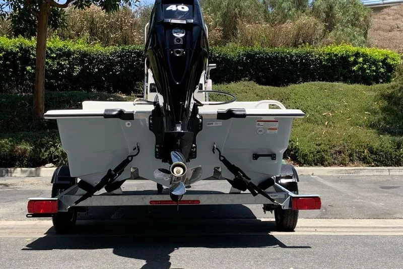 Slide: The Image of 2026 Mako Pro Skiff 13 CC boat on trailer, rear view with outboard motor. - 5