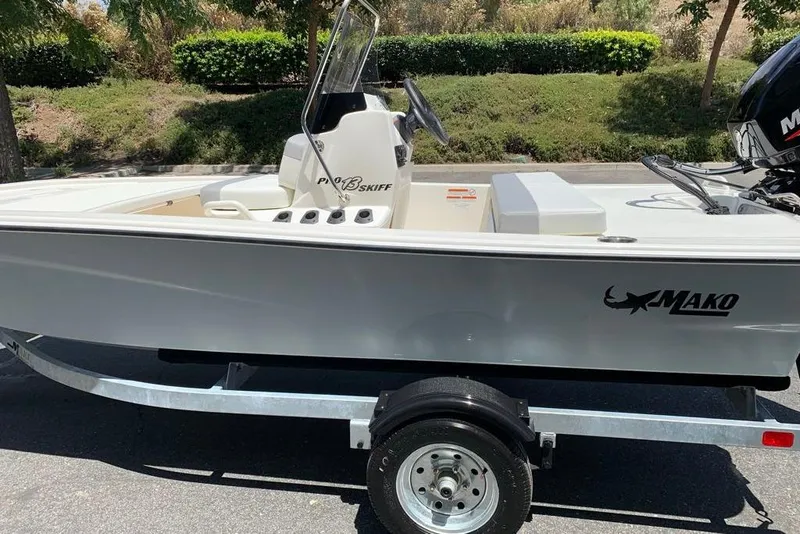 Slide: The Image of 2026 Mako Pro Skiff 13 CC boat on trailer, parked outdoors. - 4