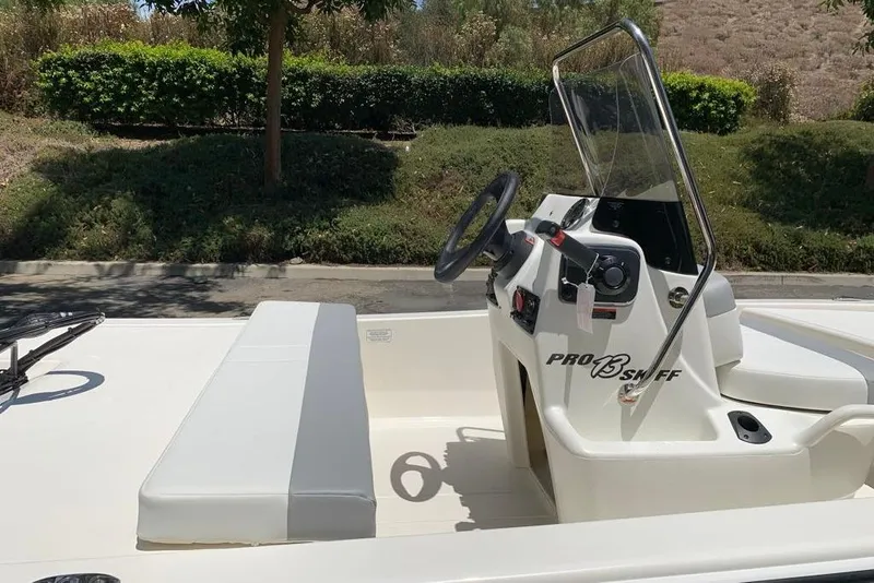 Slide: The Image of 2026 Mako Pro Skiff 13 CC boat interior with steering console and seating. - 7