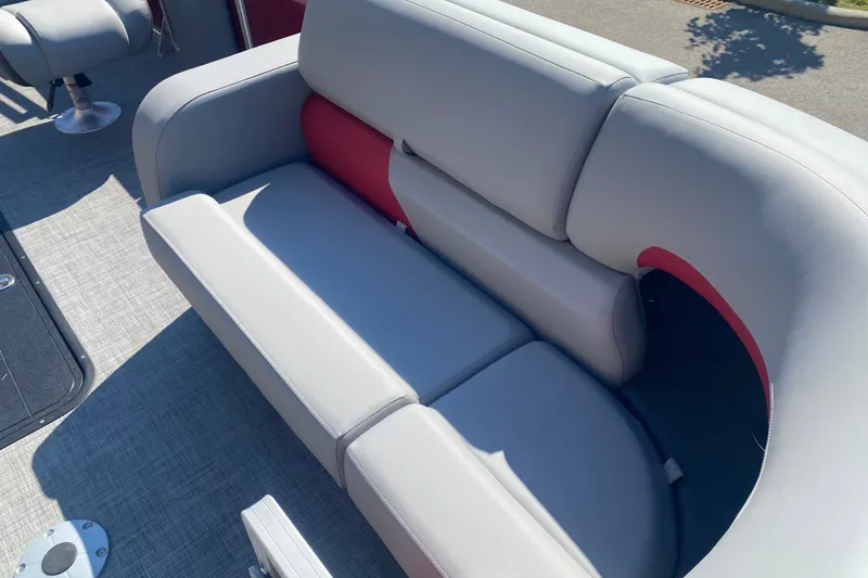 Slide: The Image of 2026 Sun Tracker Party Barge 22 RF XP3, featuring comfortable gray seating with red accents. - 6