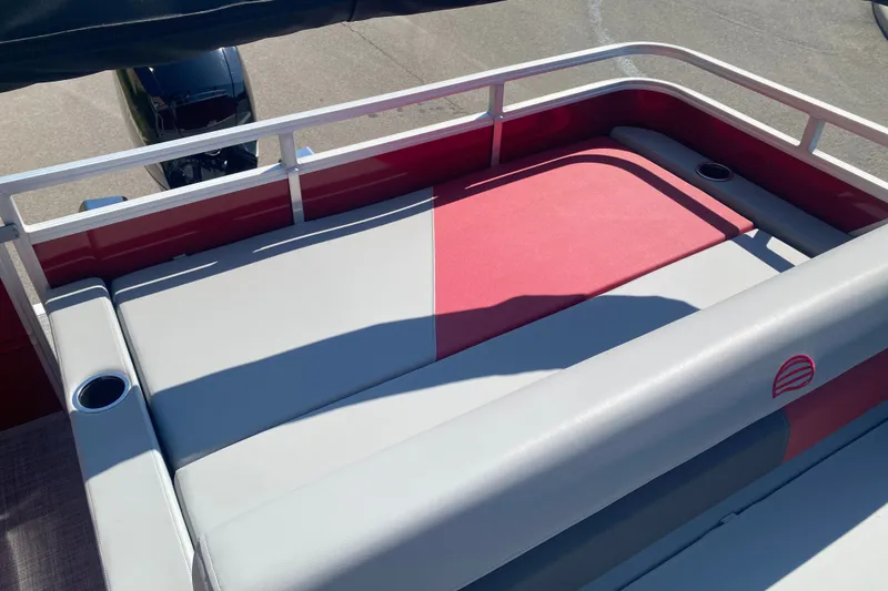 Slide: The Image of 2026 Sun Tracker Party Barge 22 RF XP3, red and gray seating area with cup holders. - 8