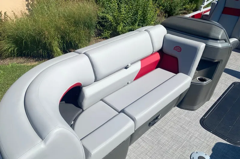 Slide: The Image of 2026 Sun Tracker Party Barge 22 RF XP3 with gray and red seating, outdoor setting. - 5