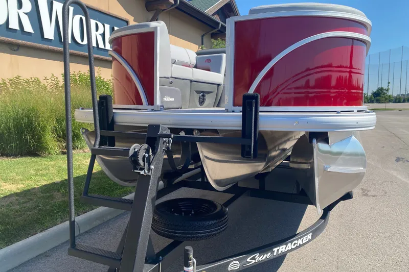Slide: The Image of 2026 Sun Tracker Party Barge 22 RF XP3 pontoon boat on trailer, vibrant red exterior. - 3