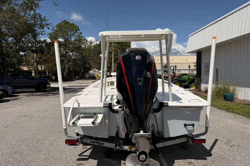 Slide: The Image of 2026 Mako 18 Pro Skiff boat with outboard motor, parked outdoors on a sunny day. - 3