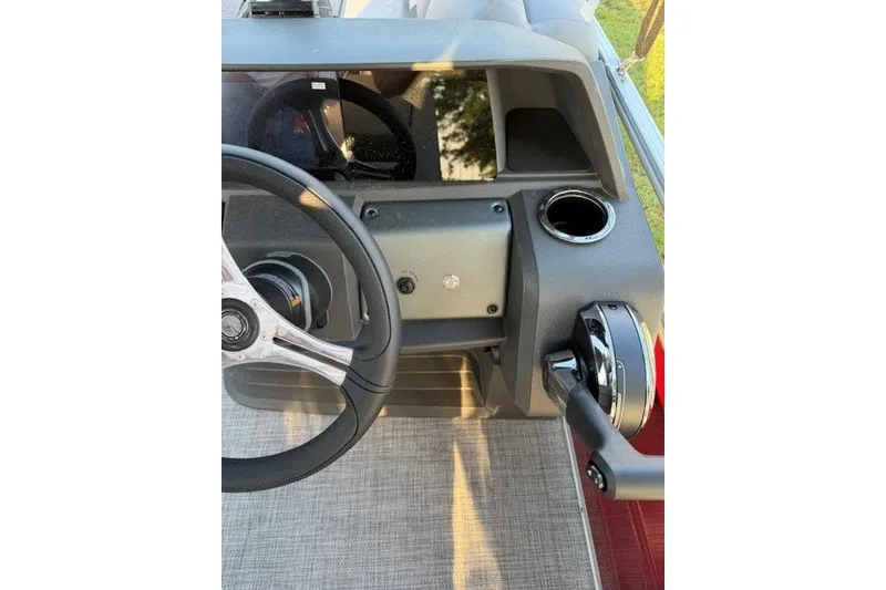 Slide: The Image of 2026 Sun Tracker SportFish 20 DLX dashboard with steering wheel and controls. - 14