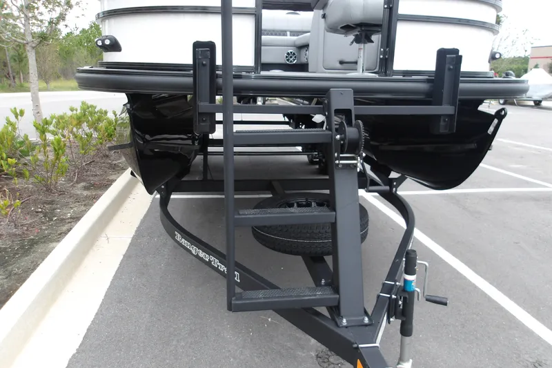 Slide: The Image of Front view of a 2026 Ranger 220F boat on a trailer in a parking lot. - 28
