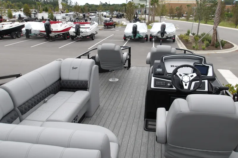 Slide: The Image of 2026 Ranger 220F pontoon boat interior with gray seating and modern dashboard. - 23