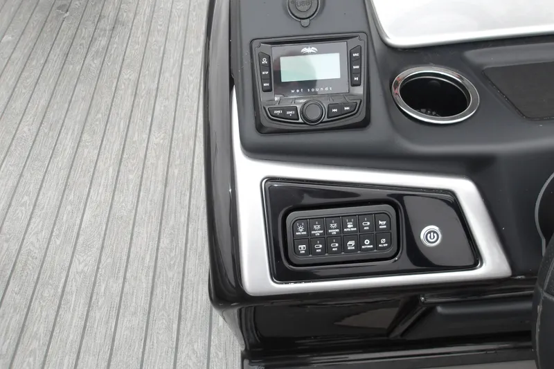 Slide: The Image of Control panel of 2026 Ranger 220F boat with audio system and switches. - 24
