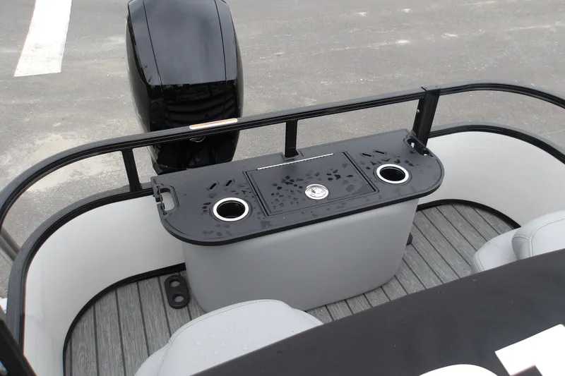 Slide: The Image of 2026 Ranger 220F boat stern with motor, featuring cup holders and seating. - 19
