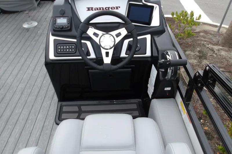 Slide: The Image of 2026 Ranger 220F boat dashboard with steering wheel and control panel. - 18