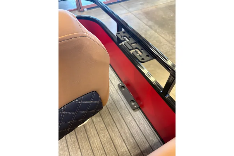 Slide: The Image of 2026 Ranger 223F interior detail with tan and black seating, red panel, and metal frame. - 15
