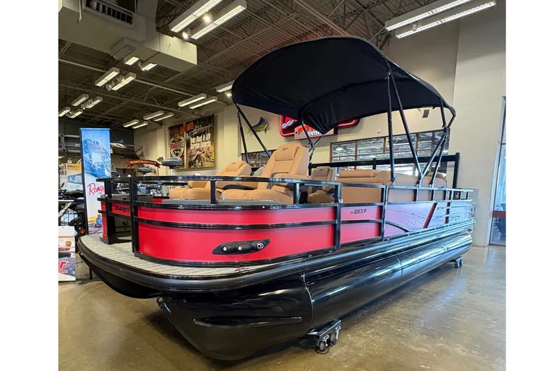 The Image of 2026 Ranger 223F pontoon boat with red and black design in showroom. - 0