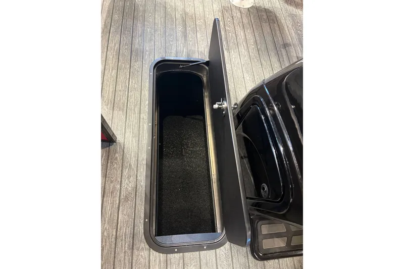 Slide: The Image of Open storage compartment on 2026 Ranger 223F boat, featuring sleek design and spacious interior. - 14