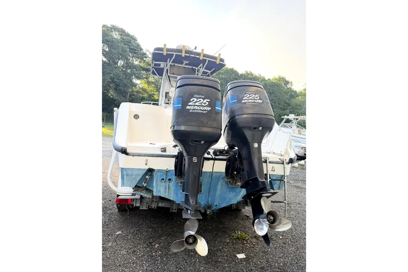 Slide: The Image of Boston Whaler 260 Outrage 2000 with twin Mercury 225 engines, parked outdoors. - 3