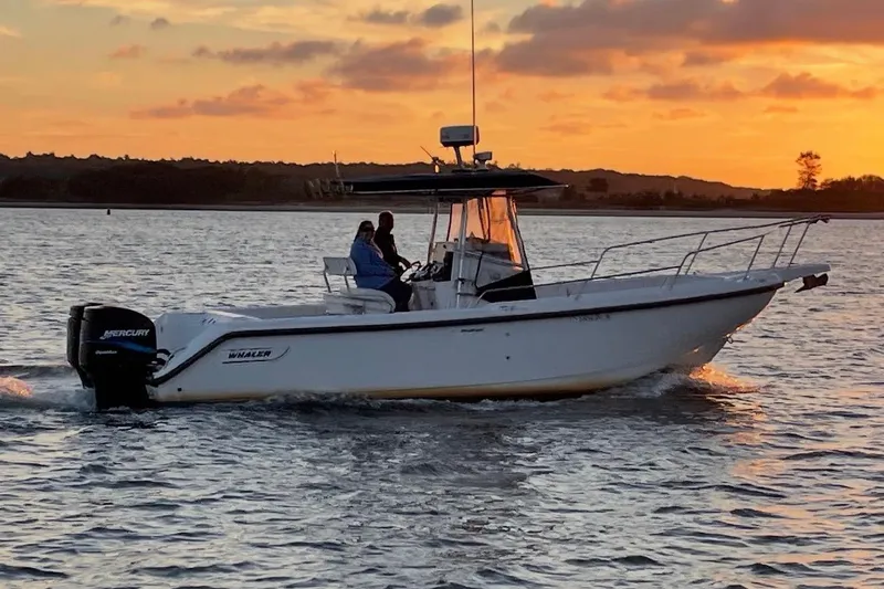 Slide: The Image of Boston Whaler 260 Outrage 2000 cruising at sunset on calm waters. - 6