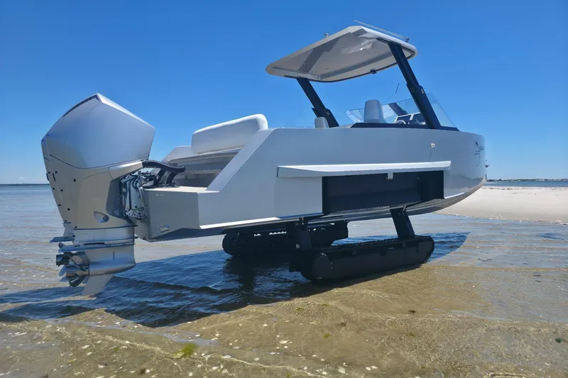 Slide: The Image of Amphibious Iguana Commuter 2025 boat on beach with retractable tracks and outboard motor. - 12