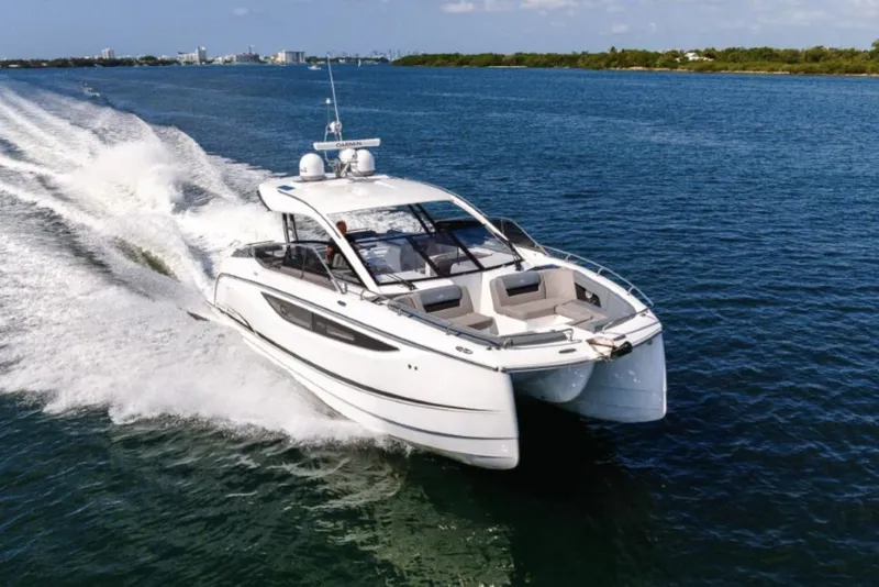 Slide: The Image of Manufacturer Provided Image: 2025 Four Winns TH36 yacht cruising on open water, showcasing sleek design and performance. - 42