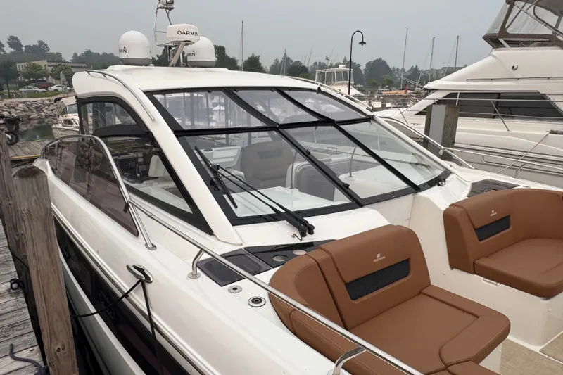 Slide: The Image of 2025 Four Winns TH36 yacht docked, featuring sleek design and luxurious seating. - 38