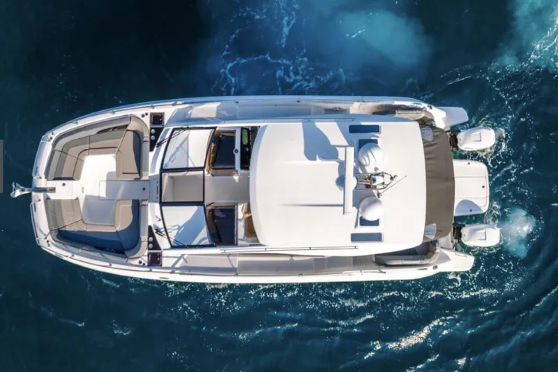 Slide: The Image of Manufacturer Provided Image: Aerial view of 2025 Four Winns TH36 yacht cruising on blue ocean waters. - 43