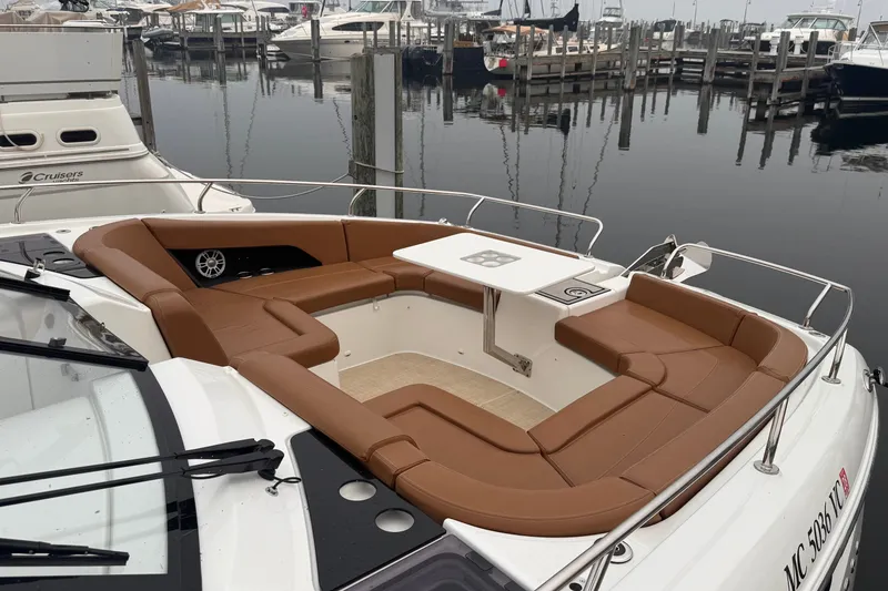 Slide: The Image of Luxurious 2025 Four Winns TH36 boat with spacious seating and table at marina. - 10