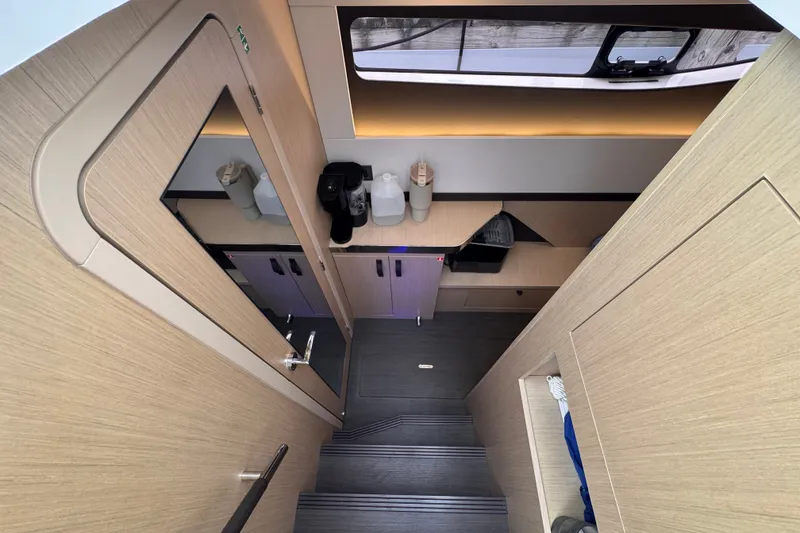 Slide: The Image of Interior of 2025 Four Winns TH36 yacht, featuring modern cabinetry and sleek design elements. - 31