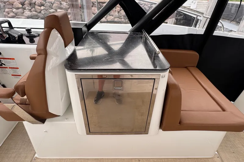 Slide: The Image of Interior of 2025 Four Winns TH36 boat with brown seating and sleek countertop. - 17