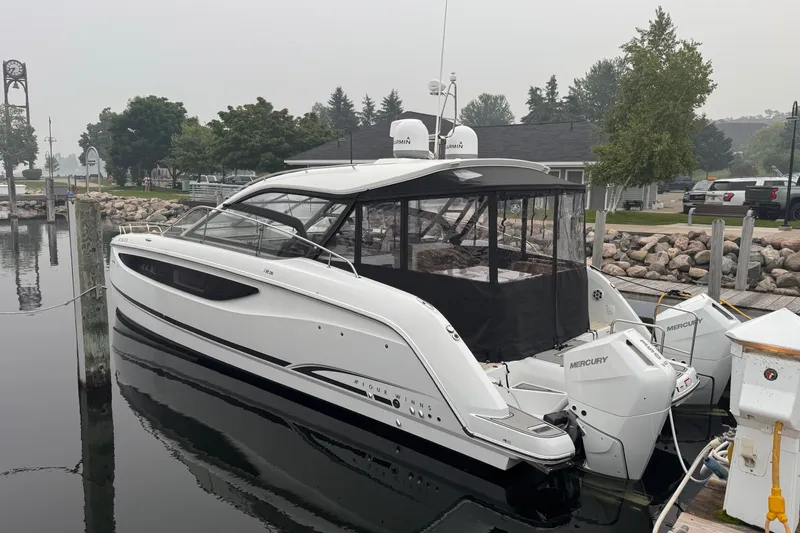 Slide: The Image of 2025 Four Winns TH36 boat docked, featuring sleek design and Mercury engines. - 8