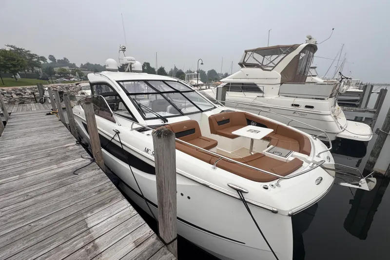 Slide: The Image of 2025 Four Winns TH36 yacht docked, featuring sleek design and spacious seating area. - 4