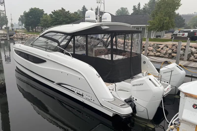 Slide: The Image of 2025 Four Winns TH36 boat docked, featuring sleek design and dual Mercury outboard engines. - 3