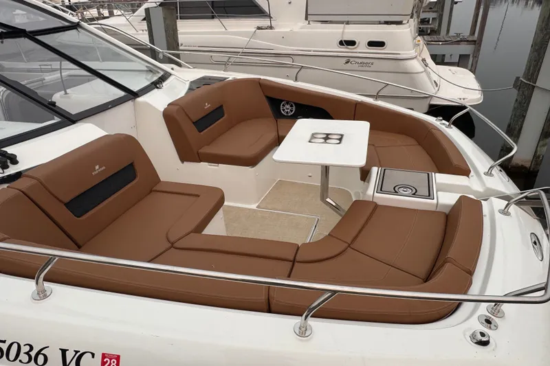Slide: The Image of 2025 Four Winns TH36 boat with brown seating and a white table in the cockpit area. - 39