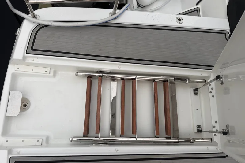 Slide: The Image of 2025 Four Winns TH36 boat swim platform with retractable ladder and teak steps. - 13
