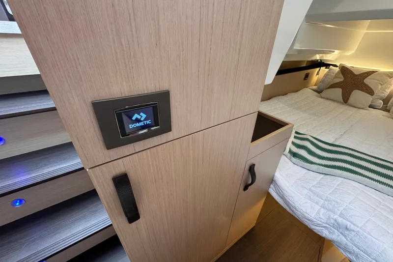 Slide: The Image of Modern cabin interior of 2025 Four Winns TH36 yacht with cozy bed and control panel. - 26