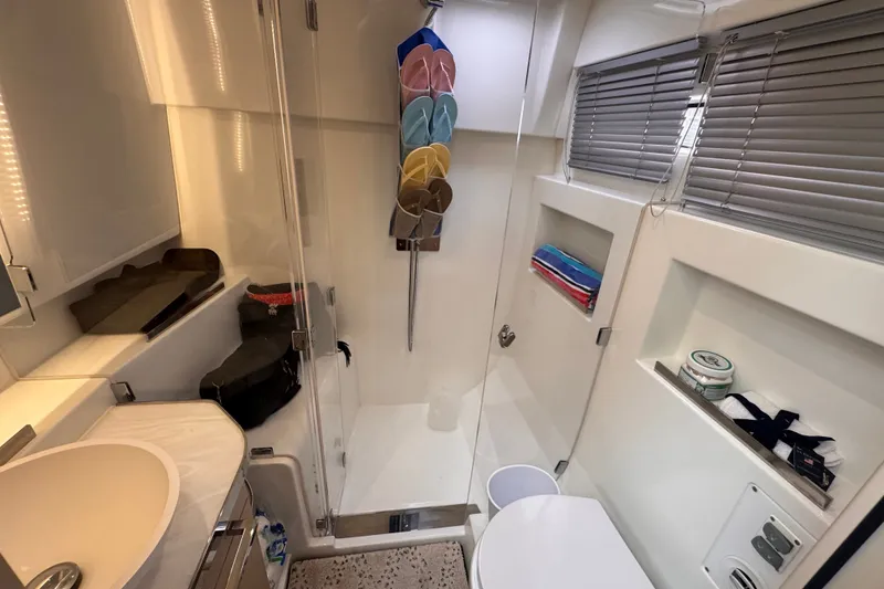 Slide: The Image of Modern bathroom interior of 2025 Four Winns TH36 yacht with shower and storage. - 33