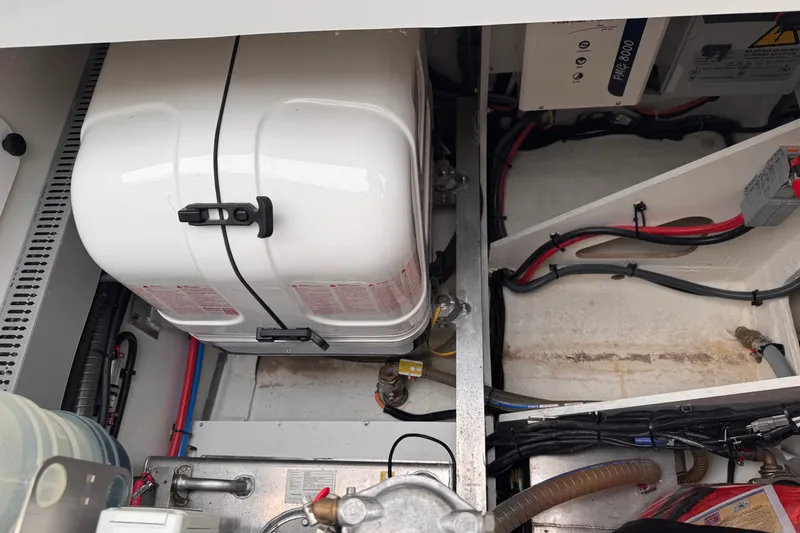 Slide: The Image of Engine compartment of 2025 Four Winns TH36 boat, showcasing wiring and equipment. - 14