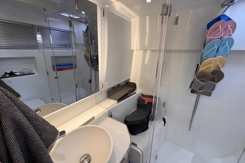 Slide: The Image of Modern bathroom interior on 2025 Four Winns TH36 yacht, featuring sleek design and organized storage. - 34