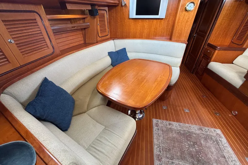 Slide: The Image of Luxurious interior of 2002 Passport 470 Center Cockpit yacht with wooden table and seating. - 39