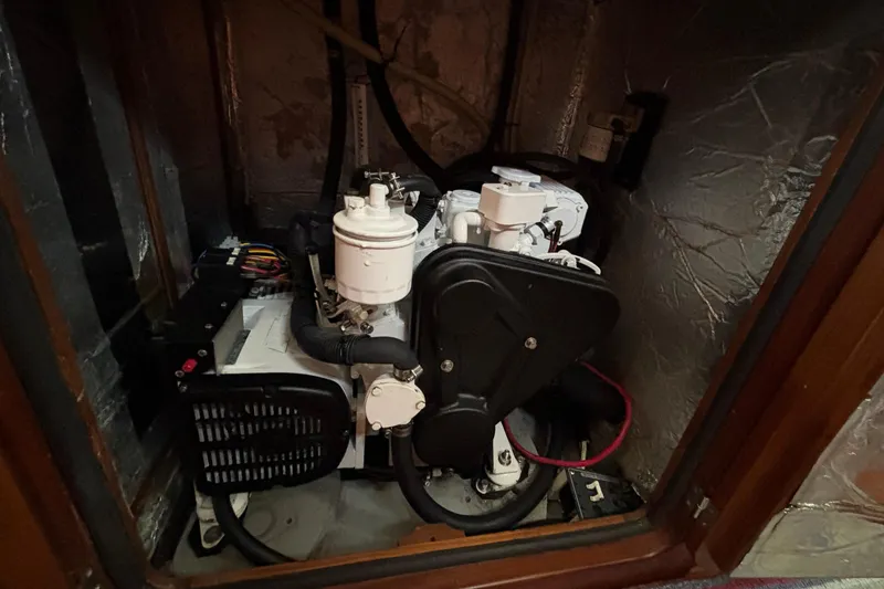 Slide: The Image of Engine compartment of a 2002 Passport 470 Center Cockpit sailboat, showcasing mechanical components. - 83
