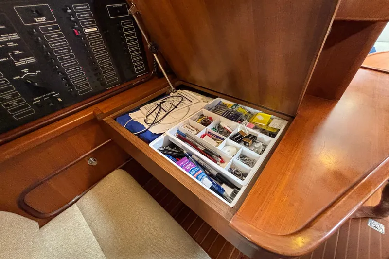 Slide: The Image of Storage compartment with organized supplies in a 2002 Passport 470 Center Cockpit yacht. - 48